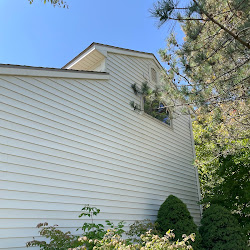 Side of house cleaned by Revitalized Exteriors